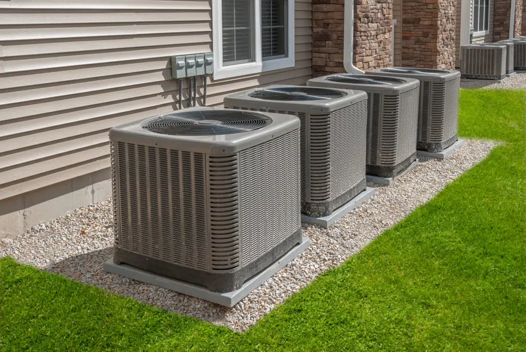 Professional HVAC technicians working on a system installation.