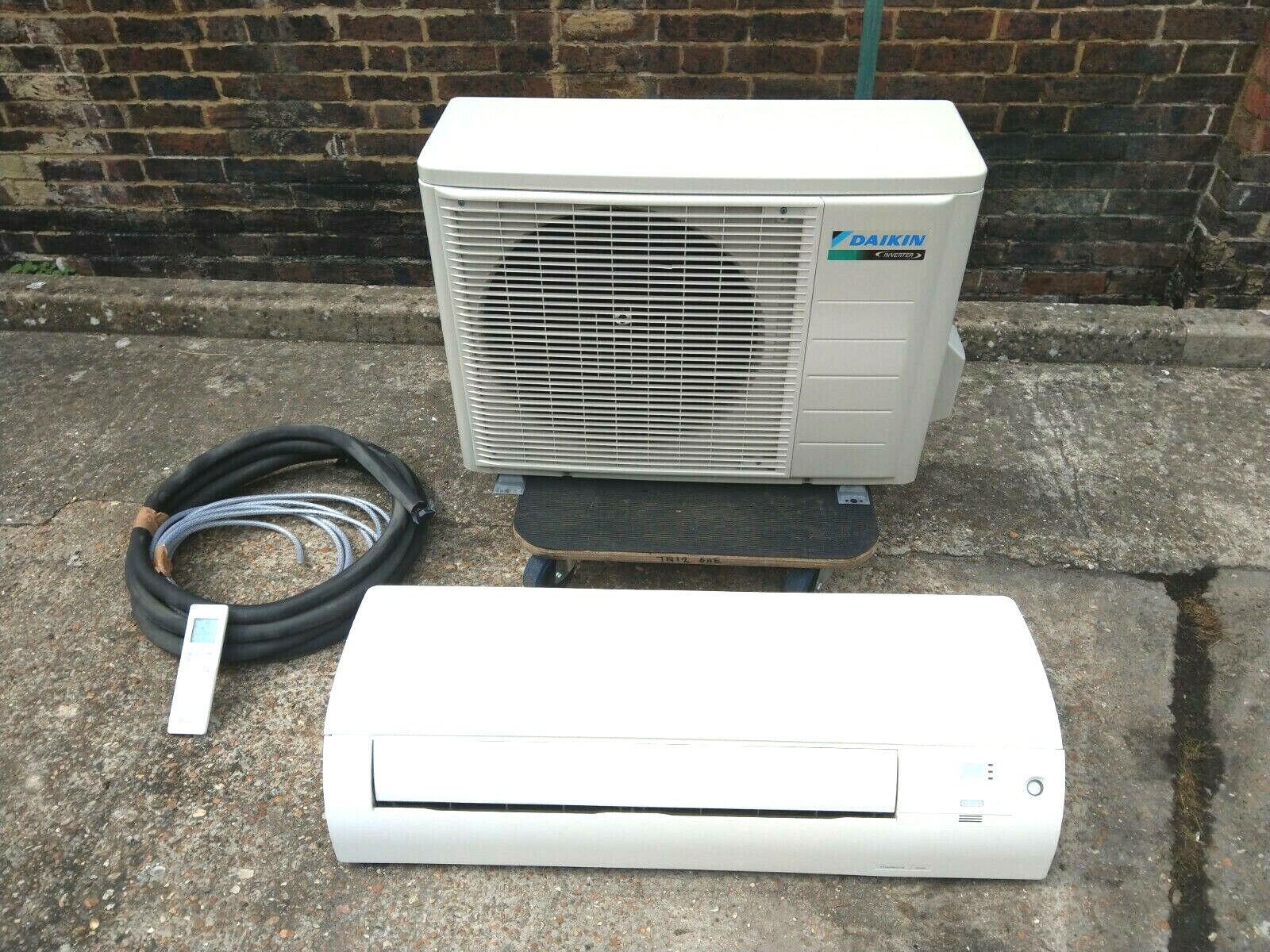 PMG Mechanical technician inspecting an air conditioning unit